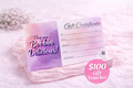 $100 Gift Voucher for Lactation Cookies on a pastel background with floral accents.